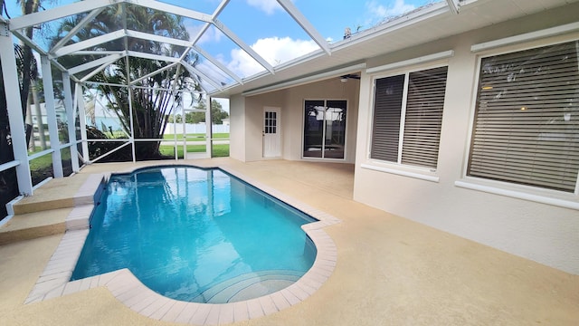 5170 NW Aljo Ct, Port Saint Lucie, FL 34986 - swimming pool with a patio area, glass enclosure, and ceiling fan