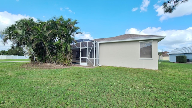 5170 NW Aljo Ct, Port Saint Lucie, FL 34986 - rear view of property featuring a lawn, stucco siding, and a lanai
