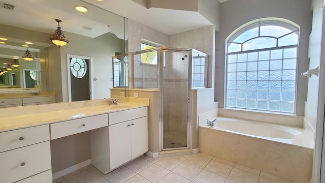 5170 NW Aljo Ct, Port Saint Lucie, FL 34986 - full bathroom with a garden tub, vanity, a stall shower, and tile patterned flooring