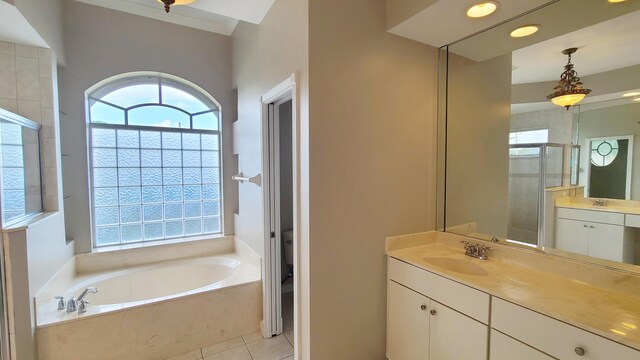 5170 NW Aljo Ct, Port Saint Lucie, FL 34986 - full bathroom featuring healthy amount of natural light, a garden tub, vanity, and a stall shower
