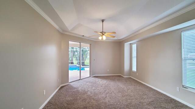 5170 NW Aljo Ct, Port Saint Lucie, FL 34986 - carpeted spare room featuring ceiling fan, ornamental molding, baseboards, and a tray ceiling