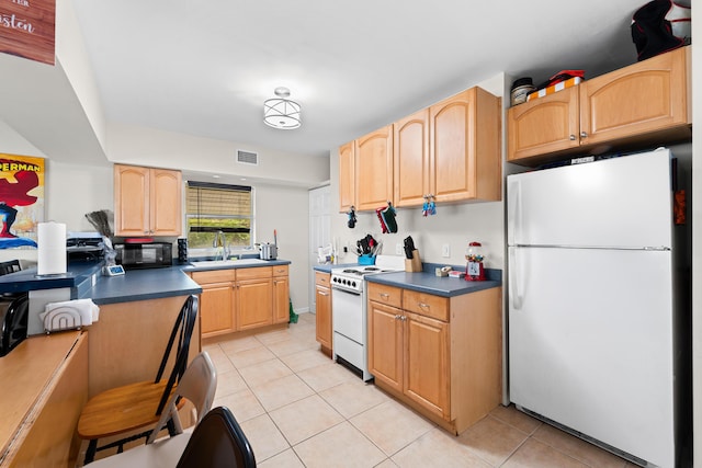 1214 Peak Rd, Lantana, FL 33462 - kitchen featuring white appliances, light tile patterned floors, and dark countertops