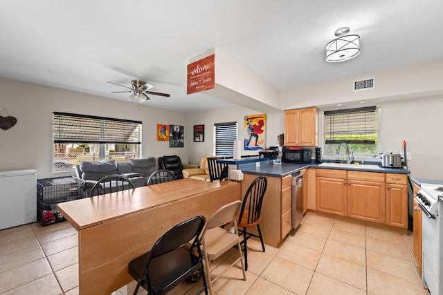 1214 Peak Rd, Lantana, FL 33462 - kitchen with dishwasher, ceiling fan, light tile patterned floors, and a peninsula