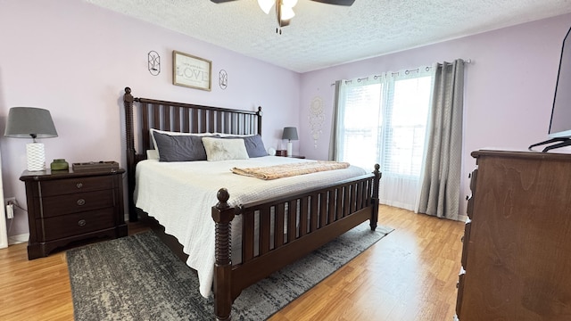 507 NW Azalea Ave, Port Saint Lucie, FL 34983 - bedroom with light wood-style flooring, a textured ceiling, and a ceiling fan