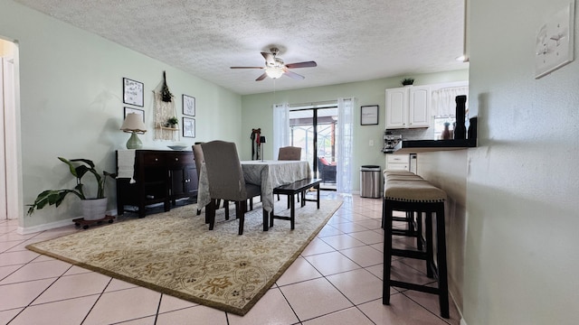 507 NW Azalea Ave, Port Saint Lucie, FL 34983 - dining space featuring ceiling fan, light tile patterned floors, a textured ceiling, and baseboards