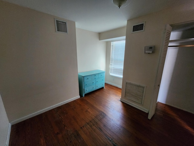 1512 Florida Ave Unit A/B, West Palm Beach, FL 33401 - unfurnished bedroom featuring dark wood-style flooring and baseboards