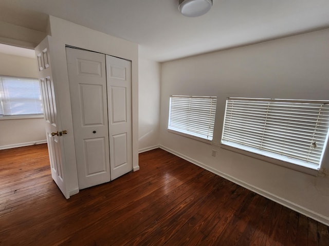 1512 Florida Ave Unit A/B, West Palm Beach, FL 33401 - unfurnished bedroom with dark wood-style flooring, a closet, and baseboards