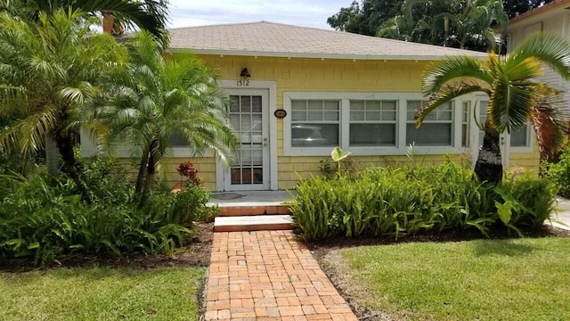 1512 Florida Ave Unit A/B, West Palm Beach, FL 33401 - entrance to property featuring roof with shingles and a yard