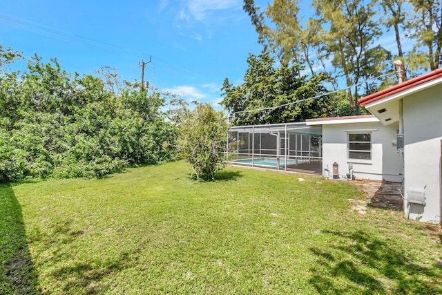 1103 NW 7th Ct, Boynton Beach, FL 33426 - view of grassy yard featuring an outdoor pool and a lanai