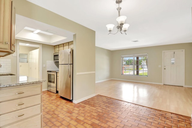 1103 NW 7th Ct, Boynton Beach, FL 33426 - kitchen with stainless steel appliances, tasteful backsplash, a chandelier, and brick patterned floors
