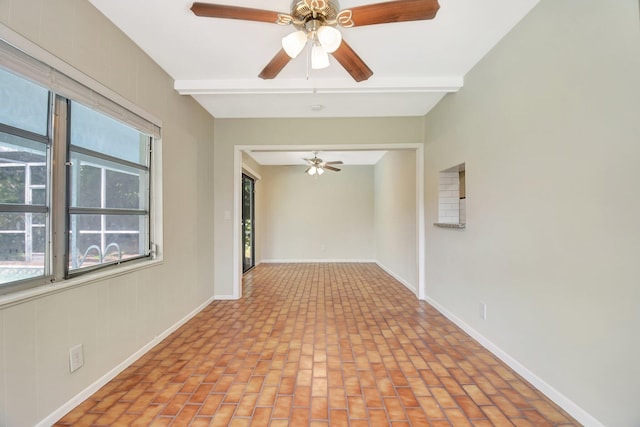 1103 NW 7th Ct, Boynton Beach, FL 33426 - empty room with a ceiling fan, brick flooring, beam ceiling, and baseboards
