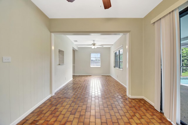 1103 NW 7th Ct, Boynton Beach, FL 33426 - unfurnished room with a ceiling fan, brick flooring, and baseboards
