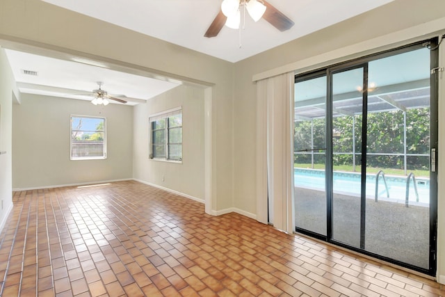 1103 NW 7th Ct, Boynton Beach, FL 33426 - spare room featuring a ceiling fan, baseboards, and brick patterned flooring