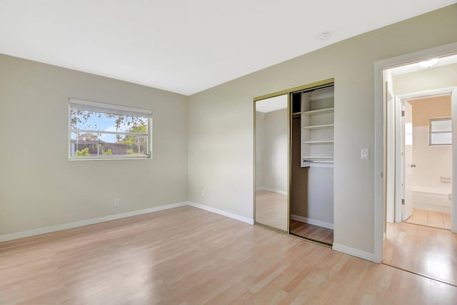 1103 NW 7th Ct, Boynton Beach, FL 33426 - unfurnished bedroom featuring light wood-style flooring, a closet, and baseboards