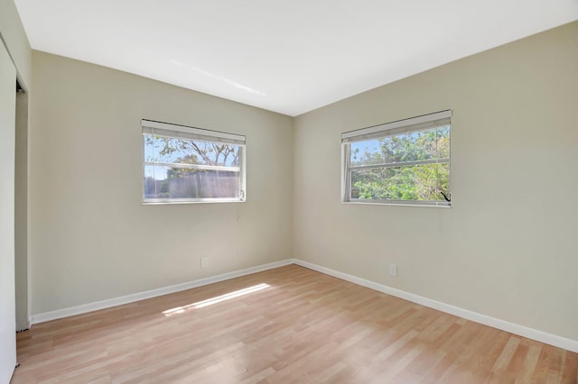 1103 NW 7th Ct, Boynton Beach, FL 33426 - unfurnished room with plenty of natural light, light wood-style floors, and baseboards