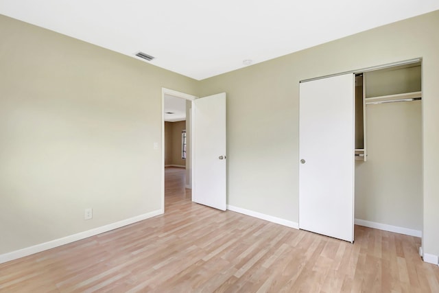 1103 NW 7th Ct, Boynton Beach, FL 33426 - unfurnished bedroom featuring light wood-style flooring, baseboards, and a closet
