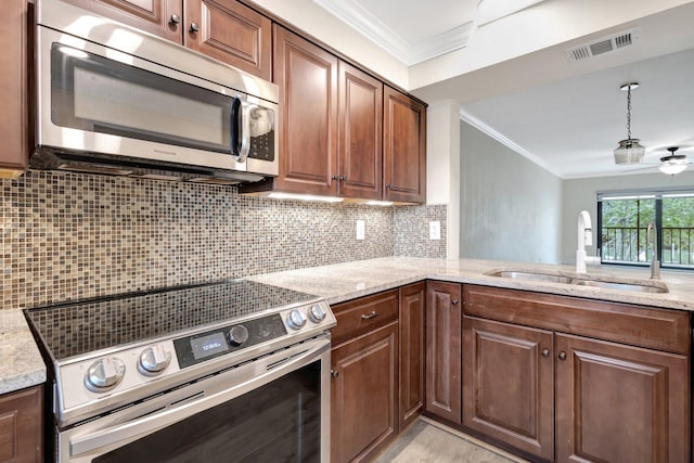 3118 Florida Blvd Unit 204-B, Delray Beach, FL 33483 - kitchen with appliances with stainless steel finishes, a sink, ornamental molding, light stone countertops, and backsplash