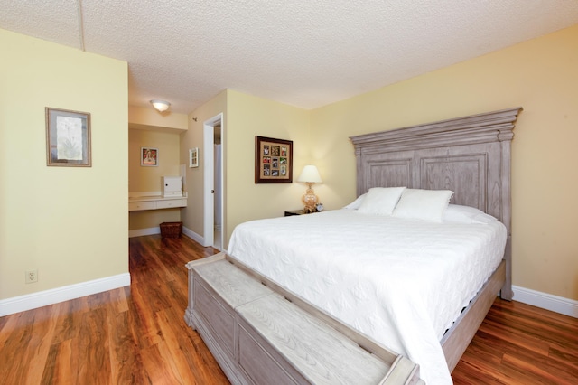 7770 Tahiti Ln Unit 408, Lake Worth, FL 33467 - bedroom featuring wood finished floors, a textured ceiling, and baseboards