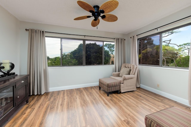7770 Tahiti Ln Unit 408, Lake Worth, FL 33467 - sitting room featuring light wood-style flooring, ceiling fan, and baseboards