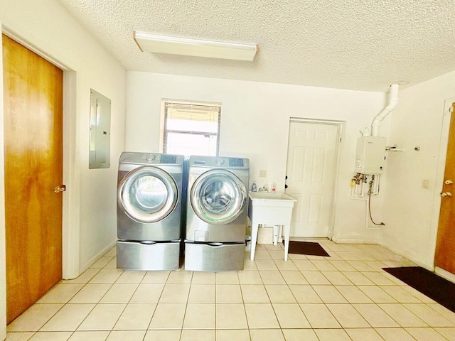 2657 River Rd, Moore Haven, FL 33471 - washroom featuring electric panel, washer and clothes dryer, a textured ceiling, water heater, and light tile patterned floors