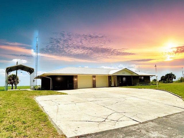 2657 River Rd, Moore Haven, FL 33471 - view of front facade featuring concrete driveway, a yard, a garage, and a detached carport