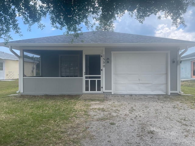1550 17th Ct SW, Vero Beach, FL 32962 - view of front of house with roof with shingles, a garage, driveway, and a front lawn