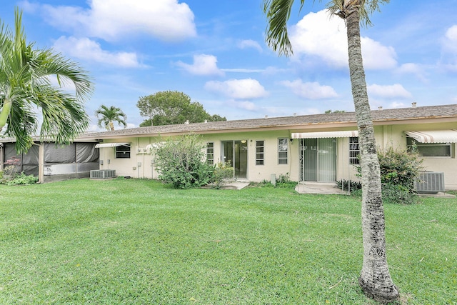 14444 Campanelli Dr, Delray Beach, FL 33484 - back of house with central AC unit, a yard, and stucco siding