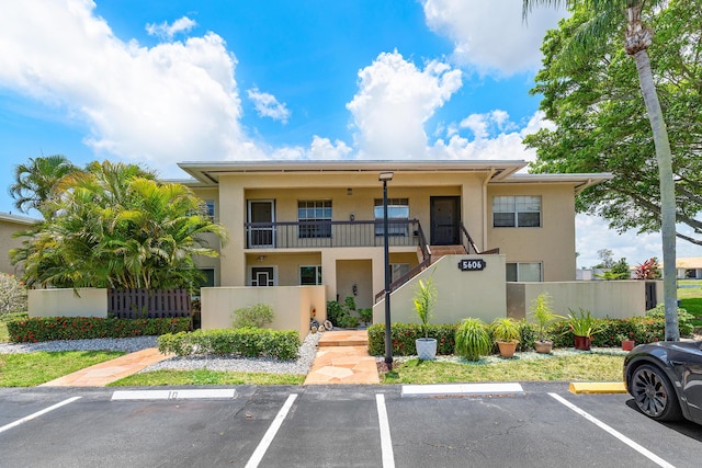 5606 Via Delray Unit B, Delray Beach, FL 33484 - view of building exterior featuring uncovered parking and stairs