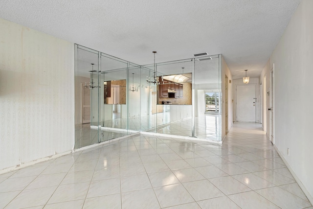5606 Via Delray Unit B, Delray Beach, FL 33484 - unfurnished room featuring a textured ceiling, light tile patterned flooring, and baseboards
