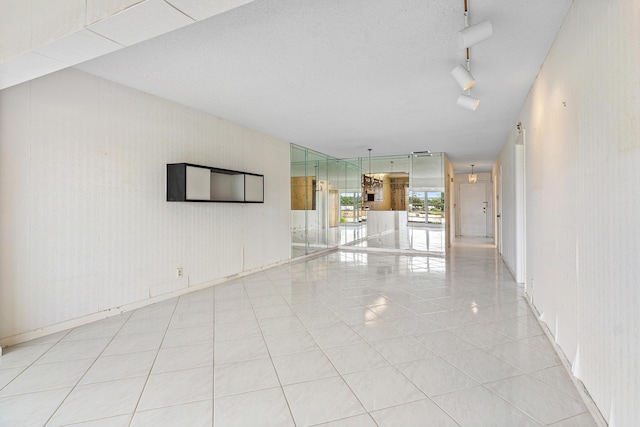 5606 Via Delray Unit B, Delray Beach, FL 33484 - tiled empty room featuring rail lighting