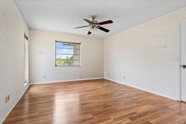 5606 Via Delray Unit B, Delray Beach, FL 33484 - spare room with wood finished floors, a ceiling fan, a textured ceiling, and wallpapered walls