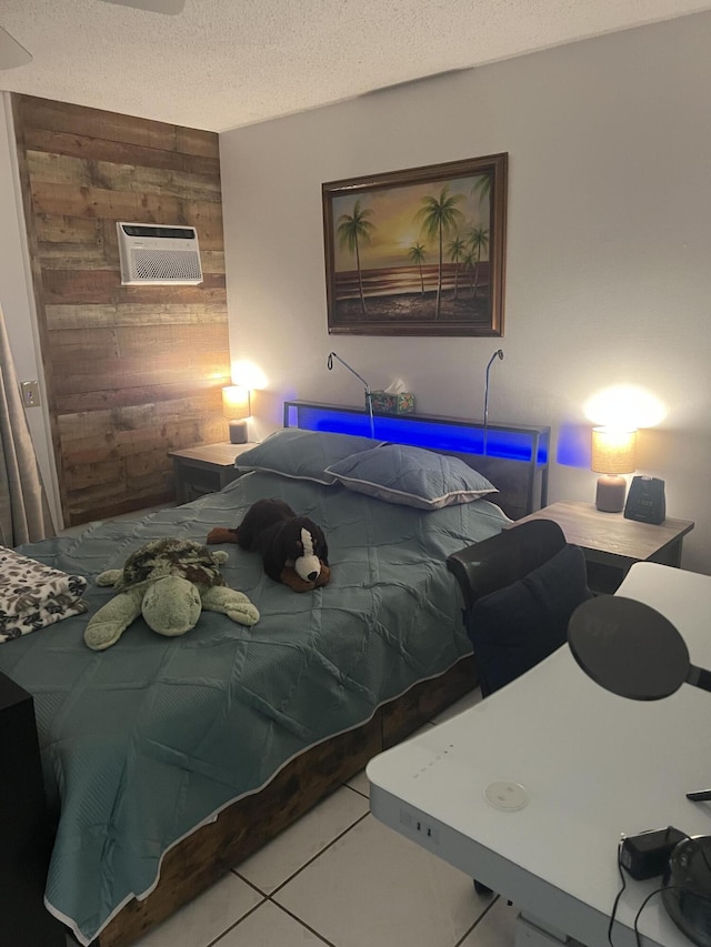 132 Berkshire F, West Palm Beach, FL 33417 - bedroom featuring wood walls, a wall mounted AC, tile patterned floors, and a textured ceiling