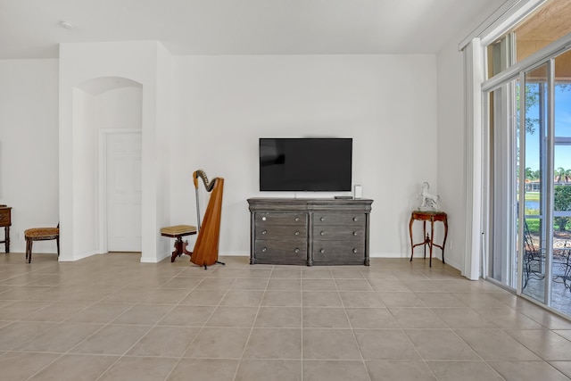 7703 Caprio Dr, Boynton Beach, FL 33472 - living area with light tile patterned flooring, baseboards, and arched walkways
