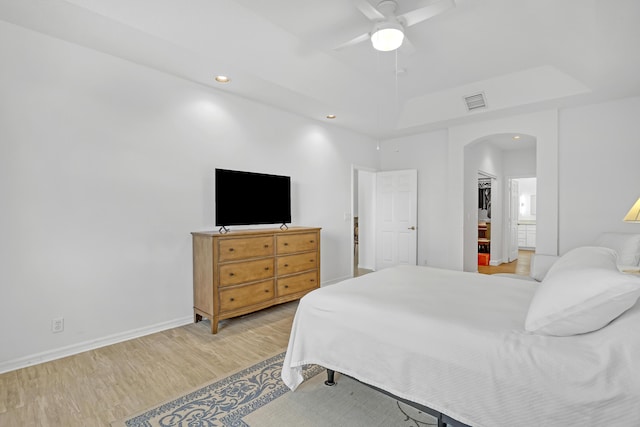 7703 Caprio Dr, Boynton Beach, FL 33472 - bedroom with arched walkways, light wood-type flooring, recessed lighting, a ceiling fan, and baseboards
