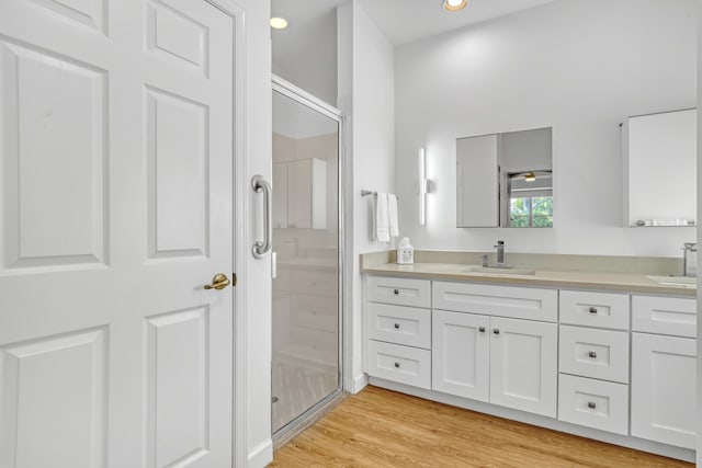 7703 Caprio Dr, Boynton Beach, FL 33472 - full bath featuring double vanity, a stall shower, wood finished floors, and recessed lighting