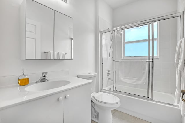 7703 Caprio Dr, Boynton Beach, FL 33472 - full bathroom featuring vanity, bath / shower combo with glass door, toilet, and tile patterned floors