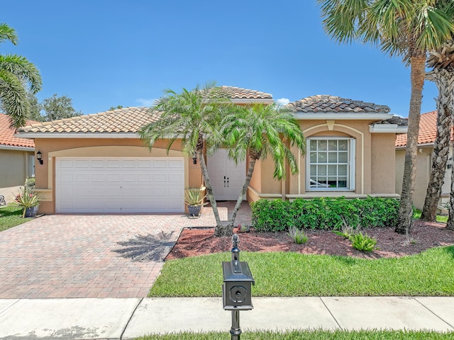 7703 Caprio Dr, Boynton Beach, FL 33472 - mediterranean / spanish home with decorative driveway, stucco siding, a tiled roof, and a garage