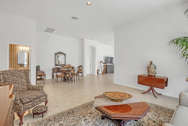7703 Caprio Dr, Boynton Beach, FL 33472 - living area featuring arched walkways, light tile patterned floors, and baseboards
