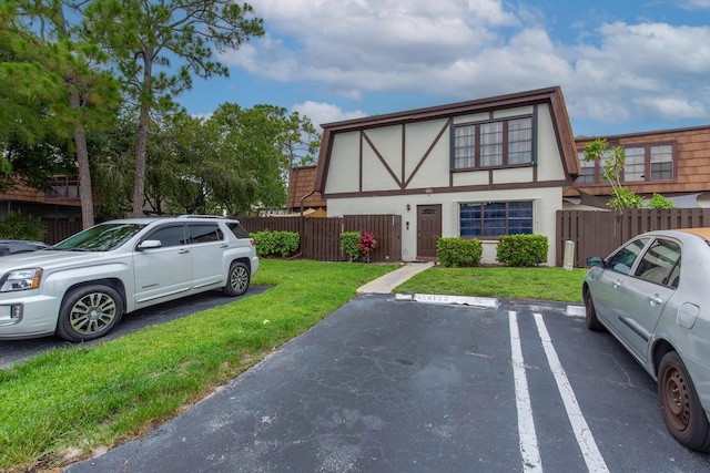 103 Weybridge C Cir Unit C, Royal Palm Beach, FL 33411 - view of front facade with stucco siding and uncovered parking