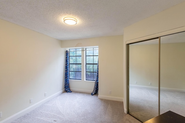 103 Weybridge C Cir Unit C, Royal Palm Beach, FL 33411 - unfurnished bedroom with carpet flooring, a textured ceiling, and a closet