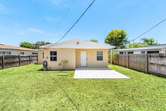 1405 N J Ter, Lake Worth Beach, FL 33460 - back of property with stucco siding, a fenced backyard, and a patio