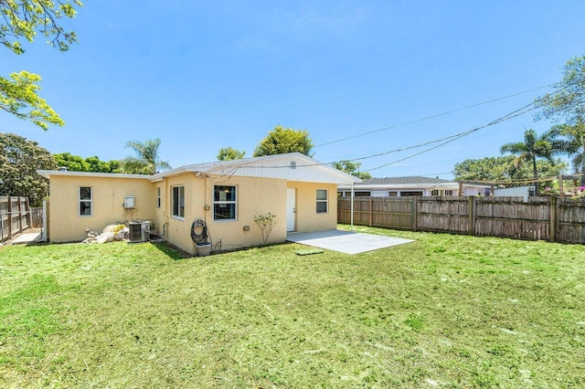 1405 N J Ter, Lake Worth Beach, FL 33460 - back of house featuring stucco siding, a fenced backyard, and a patio area