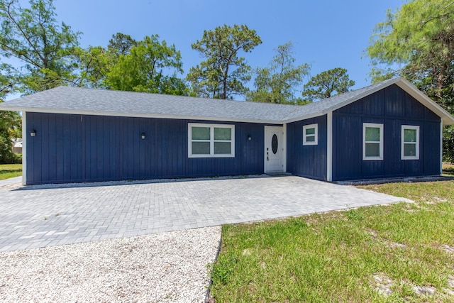16932 W Aintree Dr W, Loxahatchee, FL 33470 - view of front of house featuring a patio, a front yard, and a shingled roof