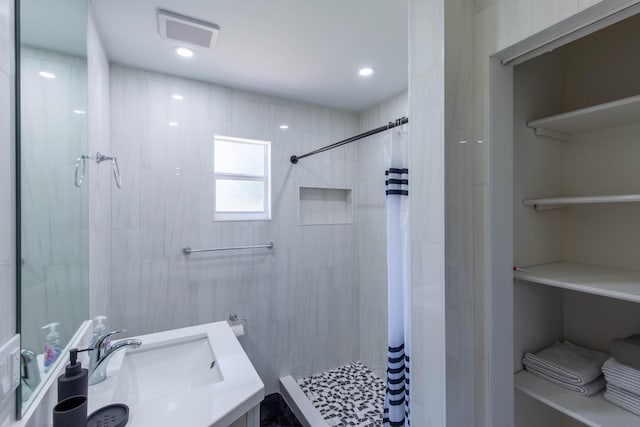 16932 W Aintree Dr W, Loxahatchee, FL 33470 - bathroom with tiled shower, vanity, and recessed lighting