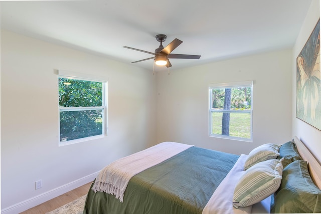 16932 W Aintree Dr W, Loxahatchee, FL 33470 - bedroom with baseboards, light wood-style flooring, and a ceiling fan
