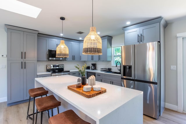 16932 W Aintree Dr W, Loxahatchee, FL 33470 - kitchen featuring appliances with stainless steel finishes, a sink, baseboards, light wood-style floors, and recessed lighting