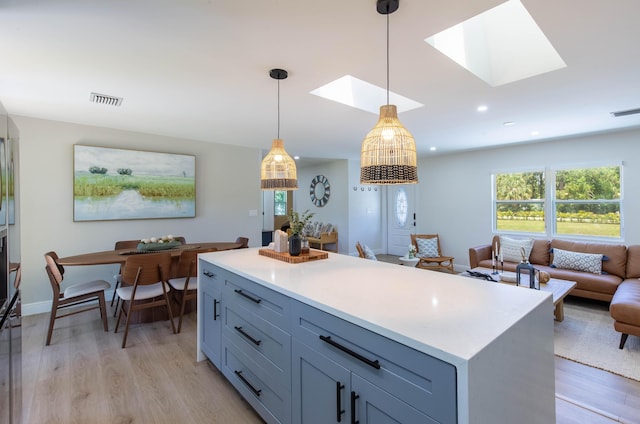 16932 W Aintree Dr W, Loxahatchee, FL 33470 - kitchen featuring healthy amount of natural light, light wood-style flooring, light countertops, pendant lighting, and recessed lighting