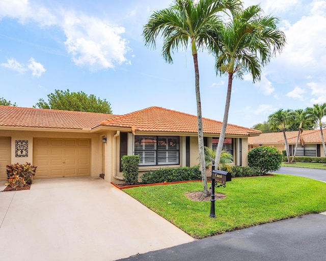 9950 Pyracantha Tree Ter Unit B, Boynton Beach, FL 33436 - view of front of home featuring a tile roof, stucco siding, concrete driveway, and an attached garage