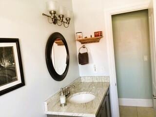 9950 Pyracantha Tree Ter Unit B, Boynton Beach, FL 33436 - bathroom featuring vanity, baseboards, and tile patterned flooring