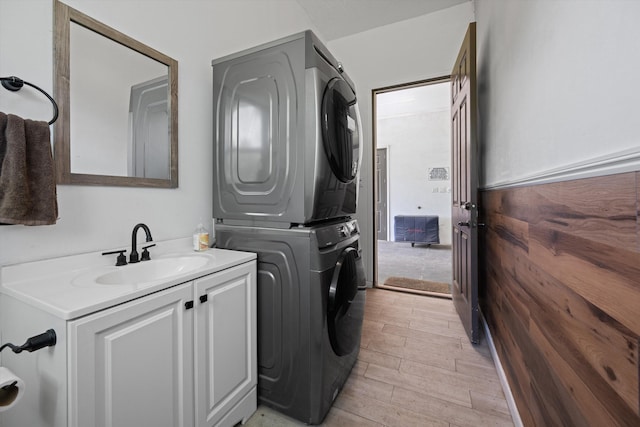 3442 C Rd, Loxahatchee Groves, FL 33470 - washroom featuring stacked washer / drying machine, cabinet space, and light wood-style flooring